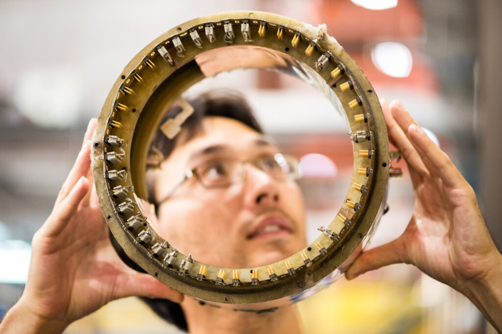 Person holding circular beamline apparatus approximately 15cm in diameter